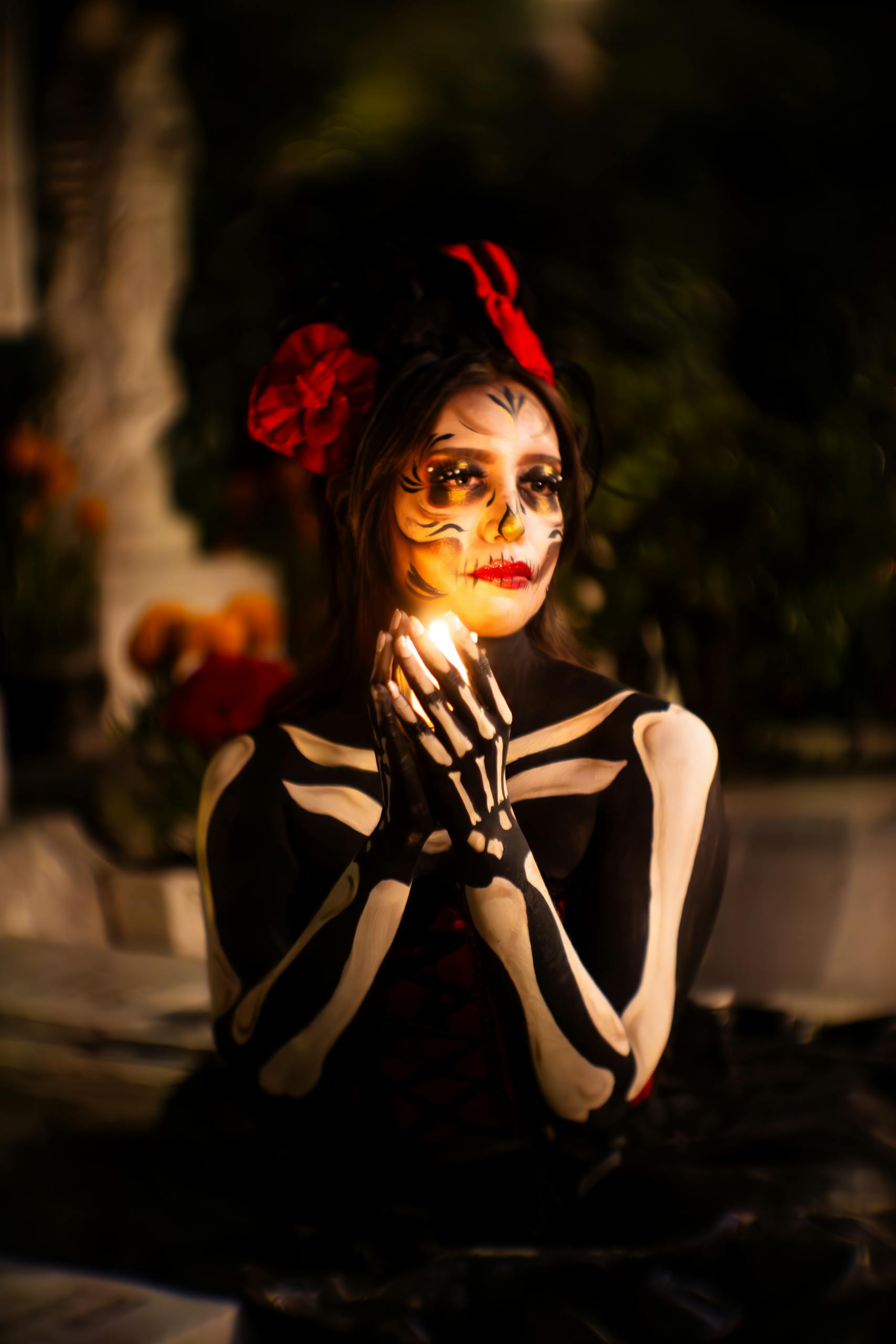 Woman in Skeleton Costume Holding Light between Hands