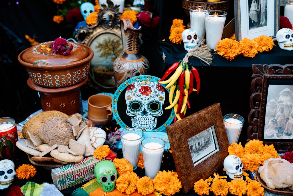 Gifts and Candles Among Skulls and Chrysanthemums on a Traditional Ofrenda Altar